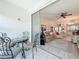 Outdoor patio seating area with a view of the living area and kitchen at 7050 Sunset Way # 22, St Pete Beach, FL 33706