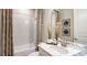 A white bathroom with a large mirror, plants and natural light, creating a luxurious space for relaxation at 731 Sky Shade Dr, Apollo Beach, FL 33572