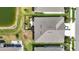 Aerial view of the home showcasing the backyard, pond, and patio at 7405 Stonebrook Cir, Wesley Chapel, FL 33545