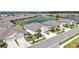 Aerial view of a neighborhood, showcasing a pond, houses, and landscaped yards at 7405 Stonebrook Cir, Wesley Chapel, FL 33545