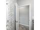 Bathroom with patterned shower curtain and an open door to another room at 7405 Stonebrook Cir, Wesley Chapel, FL 33545