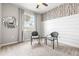 Cozy bedroom with accent wall, window, and decorative mirror at 7405 Stonebrook Cir, Wesley Chapel, FL 33545