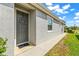 Inviting front door with a stylish wreath, welcome mat, and manicured landscaping at 7405 Stonebrook Cir, Wesley Chapel, FL 33545