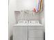 Bright laundry room featuring a Whirlpool washer and dryer and a shelf above at 7405 Stonebrook Cir, Wesley Chapel, FL 33545