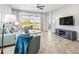 Comfortable living room with tile floors, modern decor, and beautiful views of the outdoors through the glass doors at 7405 Stonebrook Cir, Wesley Chapel, FL 33545