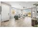 Spacious living room with tile flooring, comfortable seating, and sliding glass doors leading to the backyard at 7405 Stonebrook Cir, Wesley Chapel, FL 33545