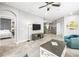 Open-concept living room with stylish decor, seamless flow to the kitchen, and comfortable seating arrangement at 7405 Stonebrook Cir, Wesley Chapel, FL 33545
