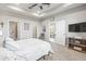 Main bedroom showcasing a ceiling fan and access to ensuite bath and walk-in closet at 7405 Stonebrook Cir, Wesley Chapel, FL 33545