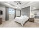 Main bedroom showcasing a tray ceiling, large window and a decorative accent wall at 7405 Stonebrook Cir, Wesley Chapel, FL 33545