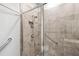 Walk-in shower featuring glass door and tile surround at 7405 Stonebrook Cir, Wesley Chapel, FL 33545