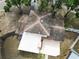 Aerial view of a home with a shingle roof, a white patio, and mature trees surrounding the property at 771 Murphy N Ave, St Petersburg, FL 33703