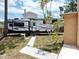 Backyard featuring a recreational vehicle (RV) parked near home with landscaping at 771 Murphy N Ave, St Petersburg, FL 33703