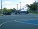 Outdoor basketball court with white lines and dark and light blue painted surface, adjacent to a skate park at 771 Murphy N Ave, St Petersburg, FL 33703