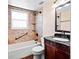 Well-lit bathroom with a tub and shower, vanity, and dark-wood cabinetry at 771 Murphy N Ave, St Petersburg, FL 33703