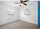 Bright bedroom with neutral carpet, a ceiling fan, and two windows that flood the room with natural light at 771 Murphy N Ave, St Petersburg, FL 33703