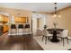 Open-concept dining area with barstool seating and modern chandelier lighting at 771 Murphy N Ave, St Petersburg, FL 33703
