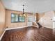 Dining area with wood floors, pendant lighting, a window with blinds and access to stairs at 771 Murphy N Ave, St Petersburg, FL 33703
