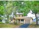 Charming two-story home with a garage, front yard, and mature trees at 771 Murphy N Ave, St Petersburg, FL 33703