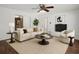 Bright living room features stylish decor, a cozy fireplace, and a ceiling fan at 771 Murphy N Ave, St Petersburg, FL 33703
