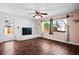 Inviting living room with stylish dark flooring, a classic brick fireplace, and a door leading to the outdoors at 771 Murphy N Ave, St Petersburg, FL 33703