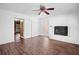 Living room featuring a white brick accent wall, a non-working fireplace, and wood flooring at 771 Murphy N Ave, St Petersburg, FL 33703