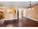 Open-concept dining and living space with wood floors, and access to the kitchen at 771 Murphy N Ave, St Petersburg, FL 33703