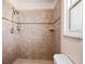 Tiled shower with coordinated brown tile, bench, and showerhead at 771 Murphy N Ave, St Petersburg, FL 33703