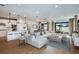 Bright and airy living room featuring a comfortable sectional sofa, stylish decor, and hardwood floors at 9950 Trellis Vine Way, Parrish, FL 34219