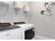 Well-equipped laundry room featuring a modern washer and dryer, along with ample storage shelves at 9954 Trellis Vine Way, Parrish, FL 34219