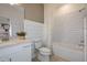 Stylish bathroom featuring white subway tiles, vanity with countertop, and combined shower-tub at 9966 Trellis Vine Way, Parrish, FL 34219