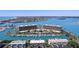 Stunning aerial view of waterfront condos with boat docks and community pool access at 1 Key Capri # 608E, Treasure Island, FL 33706
