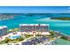 Panoramic aerial view of building, pool, parking, and surrounding coastline, for a resort-style living experience at 1 Key Capri # 608E, Treasure Island, FL 33706