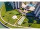 Aerial view showcasing community amenities, including a putting green, shuffleboard, pool and recreation area at 1 Key Capri # 608E, Treasure Island, FL 33706