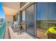 Private balcony with patio furniture and sliding glass doors offering views of water at 1 Key Capri # 608E, Treasure Island, FL 33706