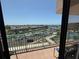 Balcony view overlooking the harbor with seating, beautiful blue sky and railing at 1 Key Capri # 608E, Treasure Island, FL 33706