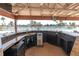 Community bar with a convenient sink and scenic views of the pool and tropical surroundings at 1 Key Capri # 608E, Treasure Island, FL 33706