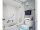 Bathroom interior showing a tub/shower combo, toilet, and towel rack with blue accents at 1 Key Capri # 608E, Treasure Island, FL 33706