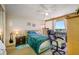 Bedroom featuring desk and comfortable chair with water view, drawers and ceiling fan at 1 Key Capri # 608E, Treasure Island, FL 33706