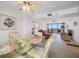 Open concept dining and living room with carpeted floors and a glass dining table set at 1 Key Capri # 608E, Treasure Island, FL 33706
