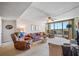 Comfortable living room with couches, a ceiling fan, a large window, and beach views at 1 Key Capri # 608E, Treasure Island, FL 33706