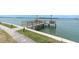 Scenic waterfront view featuring a private wooden pier extending into the tranquil water at 1 Key Capri # 608E, Treasure Island, FL 33706