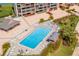 Aerial view of community pool, sundeck, and recreational area, perfect for outdoor relaxation and socializing at 1 Key Capri # 608E, Treasure Island, FL 33706