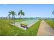 Outdoor shuffleboard court surrounded by lush landscaping and benches, perfect for community recreation and relaxation at 1 Key Capri # 608E, Treasure Island, FL 33706