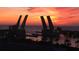 The bridge to the mainland is silhouetted by the vivid colors of the setting sun at 1 Key Capri # 608E, Treasure Island, FL 33706