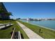 Scenic walkway along the waterfront with benches, palm trees and marina views, perfect for relaxing and enjoying the outdoors at 1 Key Capri # 608E, Treasure Island, FL 33706