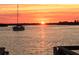A beautiful sunrise over the water with a sailboat adding to the picturesque scene at 1 Key Capri # 608E, Treasure Island, FL 33706