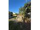 This backyard features mature trees, providing shade and privacy for relaxation and outdoor gatherings at 1013 E Lake Ave, Tampa, FL 33605