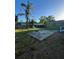View of the backyard with a concrete patio and a tall palm tree, perfect for outdoor entertaining at 1013 E Lake Ave, Tampa, FL 33605