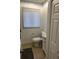 Cozy bathroom with a toilet, sink, vanity, and a closet for extra storage at 1013 E Lake Ave, Tampa, FL 33605