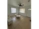 Bright living room with tile floors, two windows, and a neutral color palette at 1013 E Lake Ave, Tampa, FL 33605